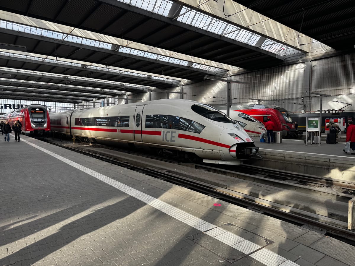 A view of Munich Hauptbahnhof showing six different trains, some of which are different models, lined up against the end of the track near the buffers in this terminus station.